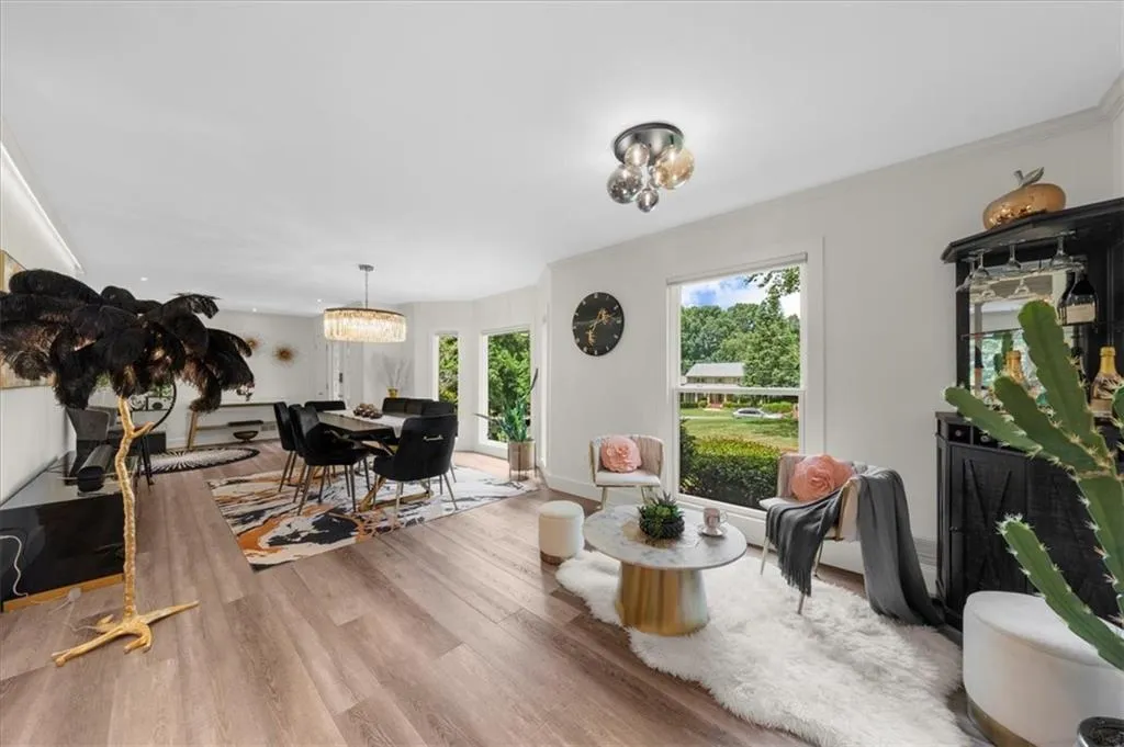 Living room featuring wood finished floors and a chandelier