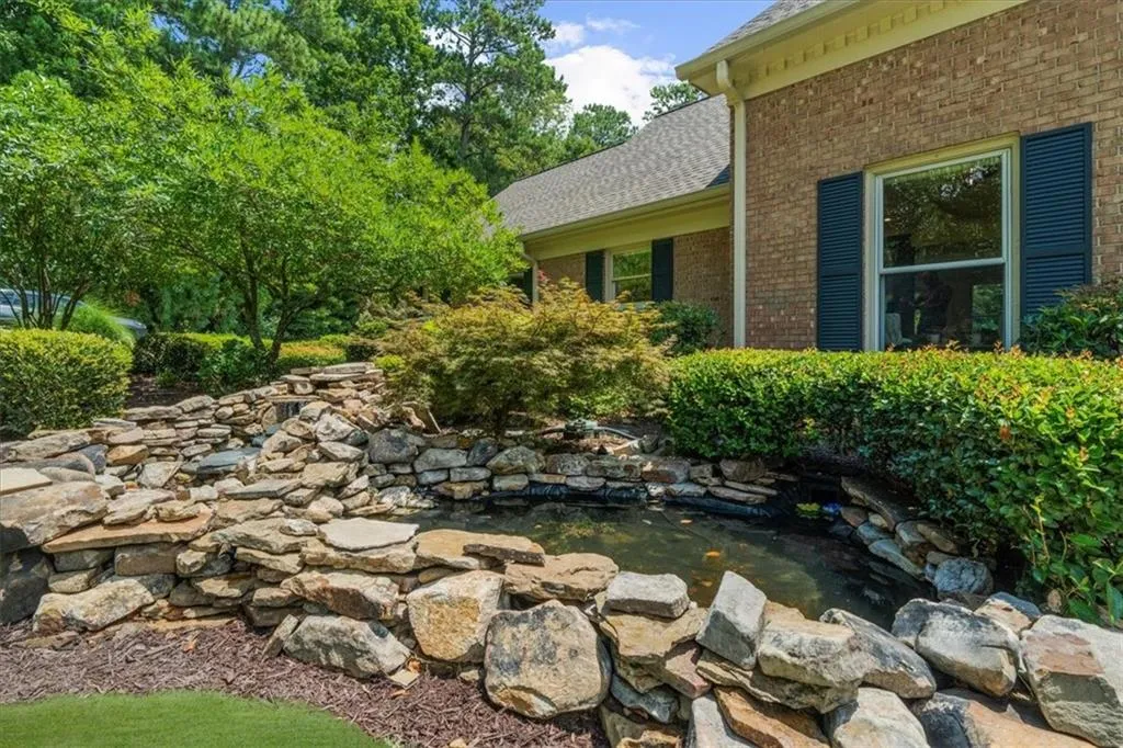 View of yard with a garden pond