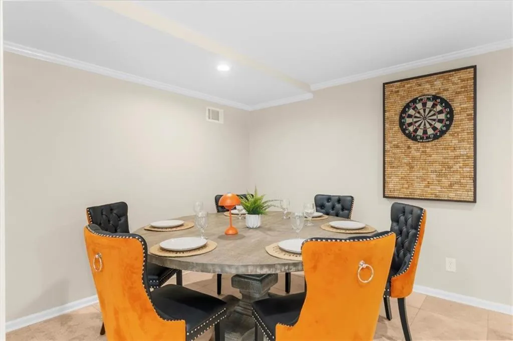 Basement dining room with crown molding and recessed lighting