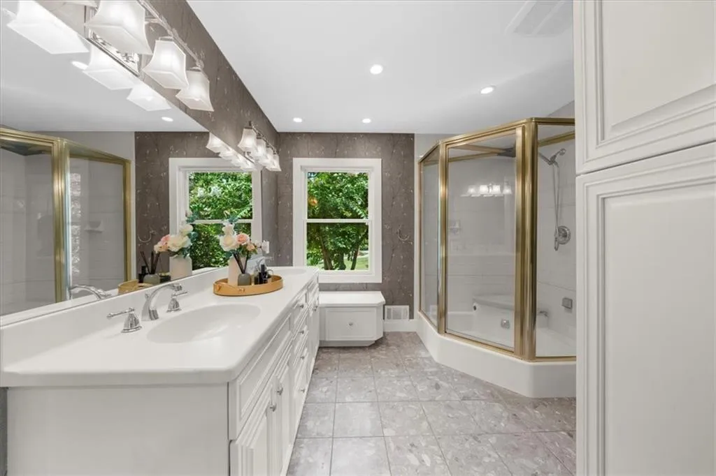 Bathroom featuring vanity, recessed lighting, a stall shower, and tile patterned floors