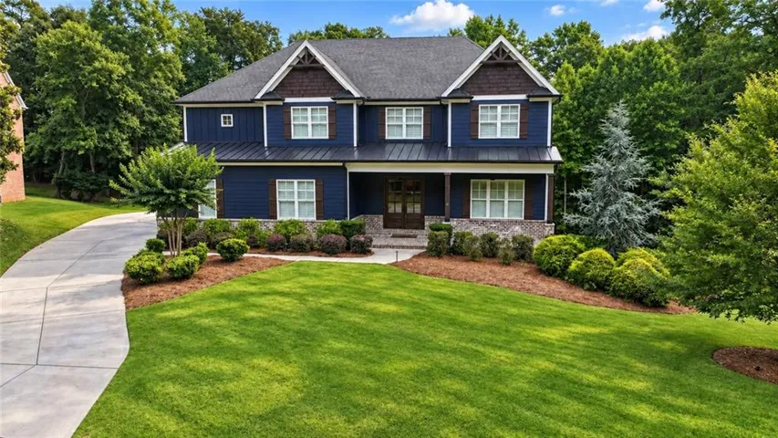 Striking curb appeal with timeless architecture and welcoming front porch sets the tone from the moment you arrive.