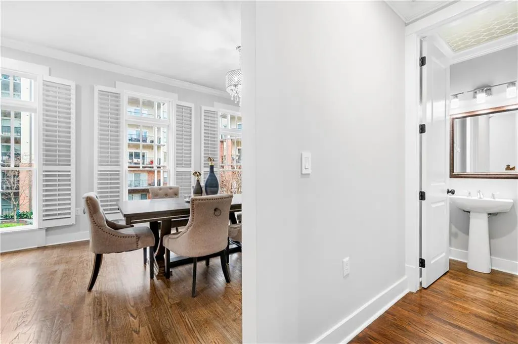 Dining room featuring ornamental molding and dark wood-style flooring