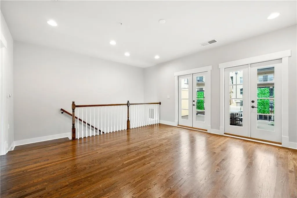 Bonus  room with french doors, wood finished floors, and recessed lighting