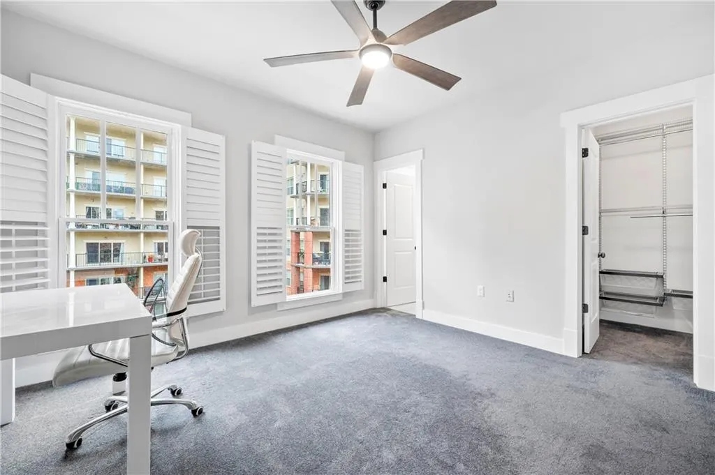 Unfurnished office with carpet flooring and ceiling fan