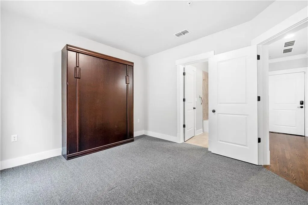 bedroom with light carpet and a closet