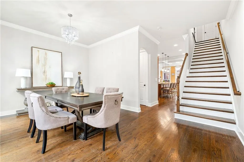 Dining room featuring crown molding, hanging lights, and wood-type flooring