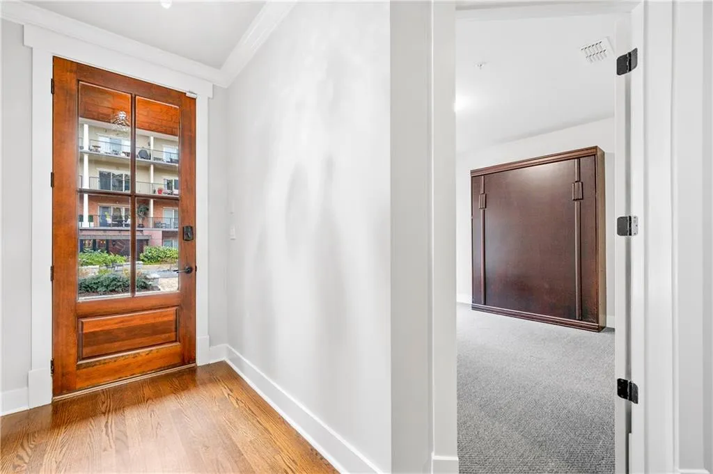 Entryway featuring baseboards and ornamental molding