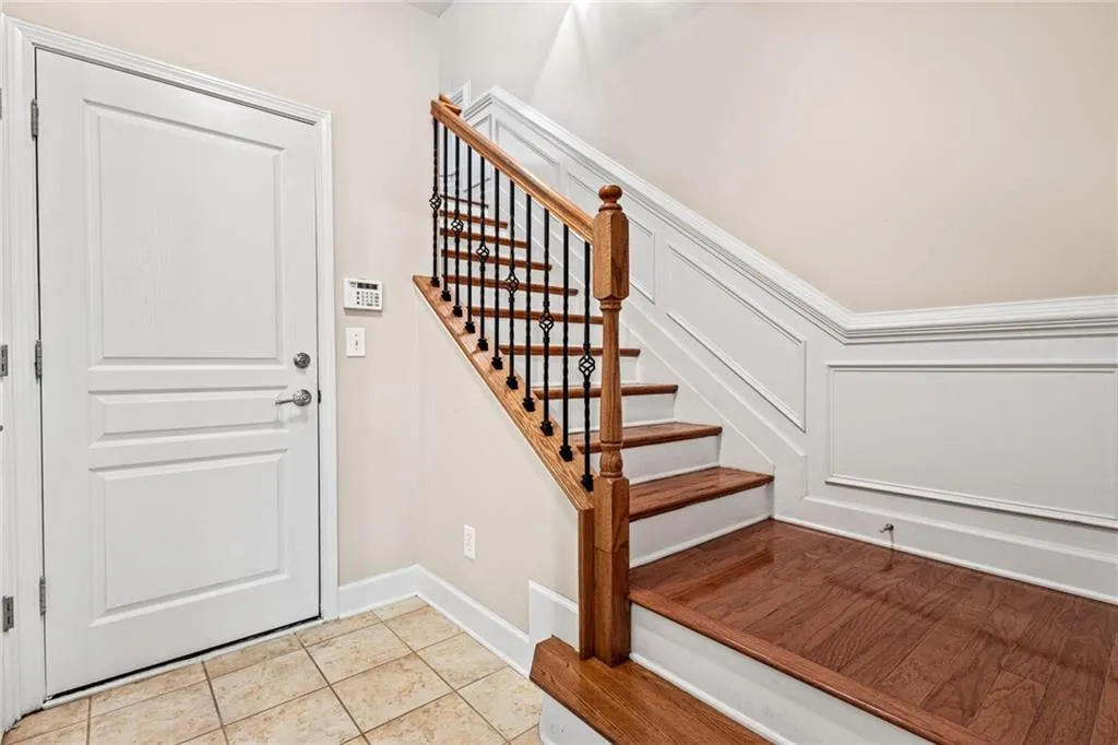 Entryway with light tile patterned flooring and stairs