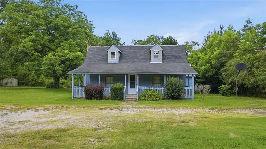 Light blue exterior with a covered front porch and two dormer windows