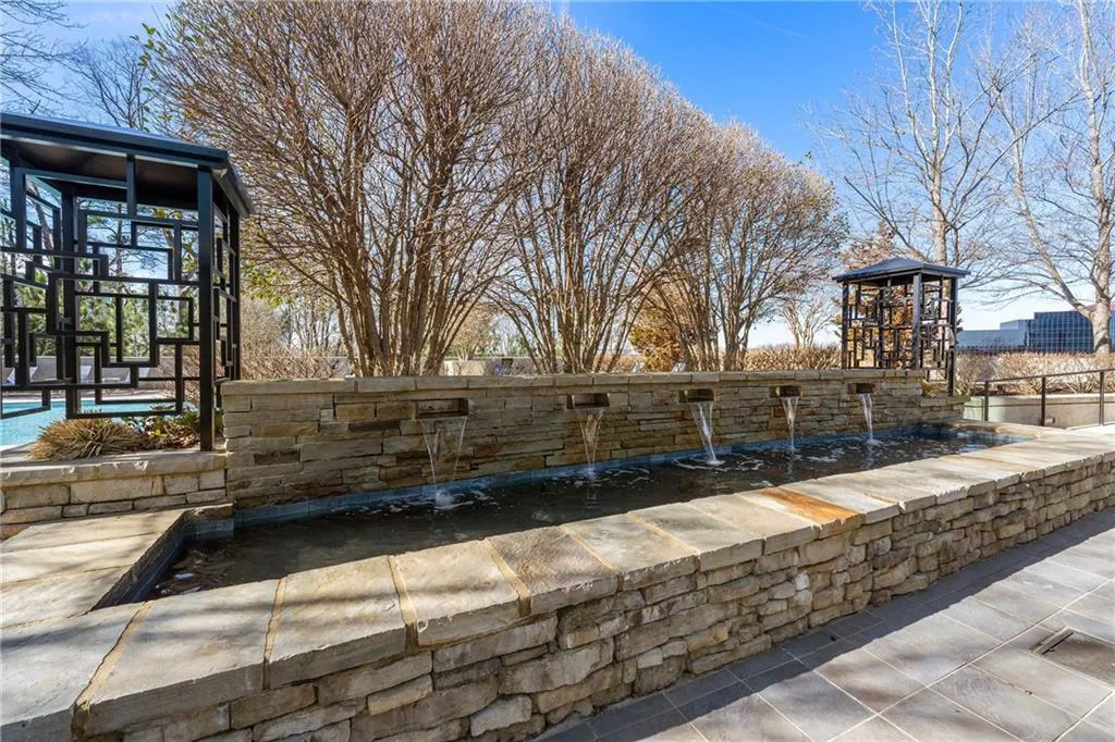 View of fountain on terrace with  swimming pool and spa