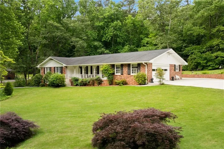Brick exterior with white siding accents and a covered front porch
