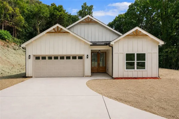 White board and batten exterior with wood accent gables