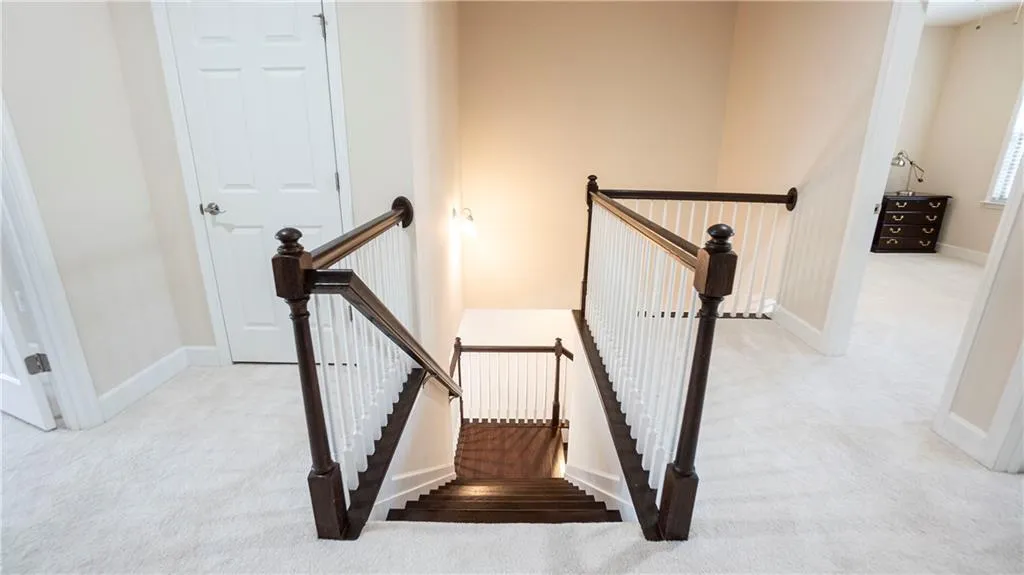 Staircase featuring carpet and baseboards
