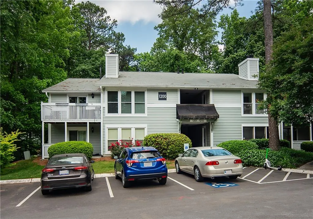View of property with uncovered parking
