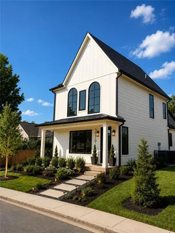 White vertical siding exterior with a dark shingle roof