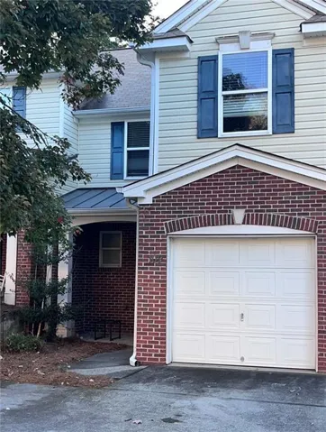 View of front facade with brick siding and two car garage
