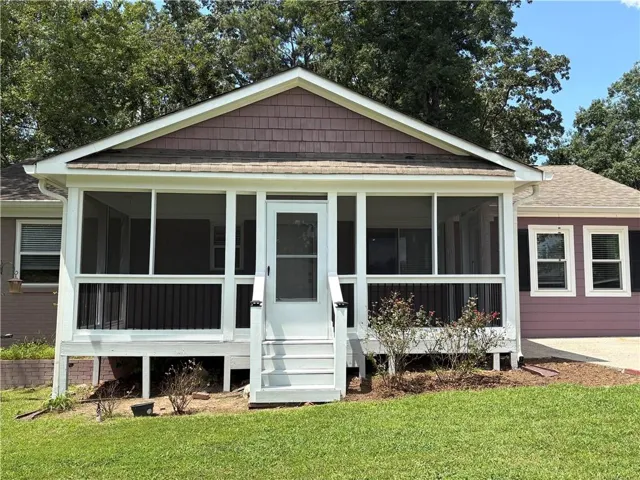 Screened porch with white railings and exterior steps