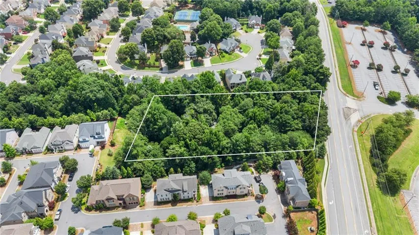 Expansive wooded lot outlined in white, surrounded by established residential properties