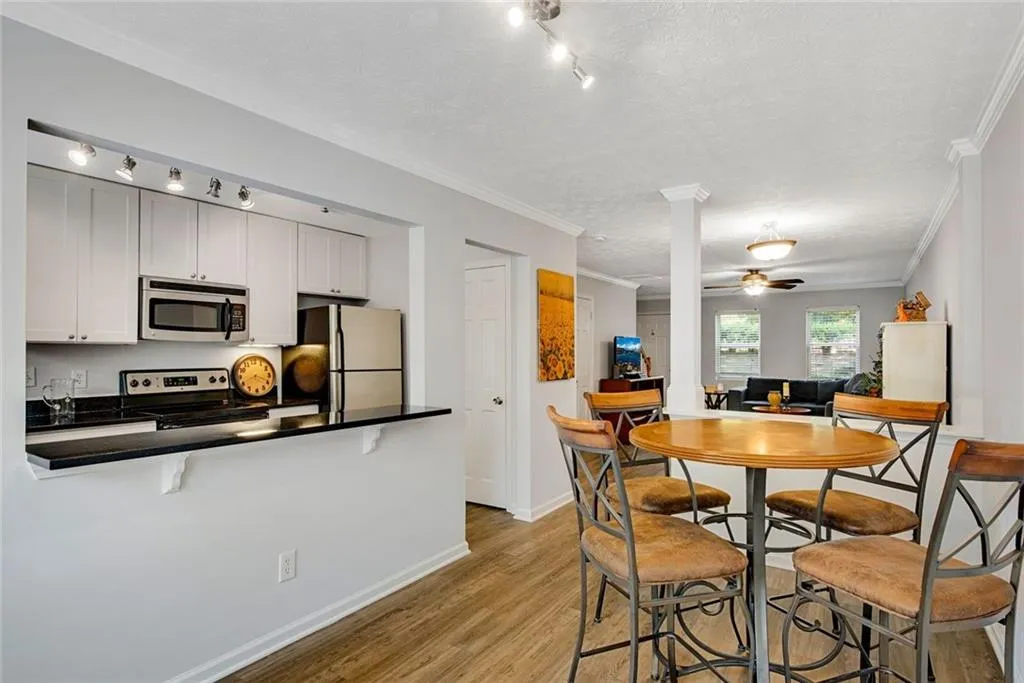Dining room w/ view of kitchen bar seating