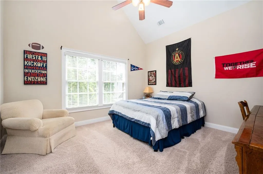 Bedroom 2 with high vaulted ceiling and walk in closet