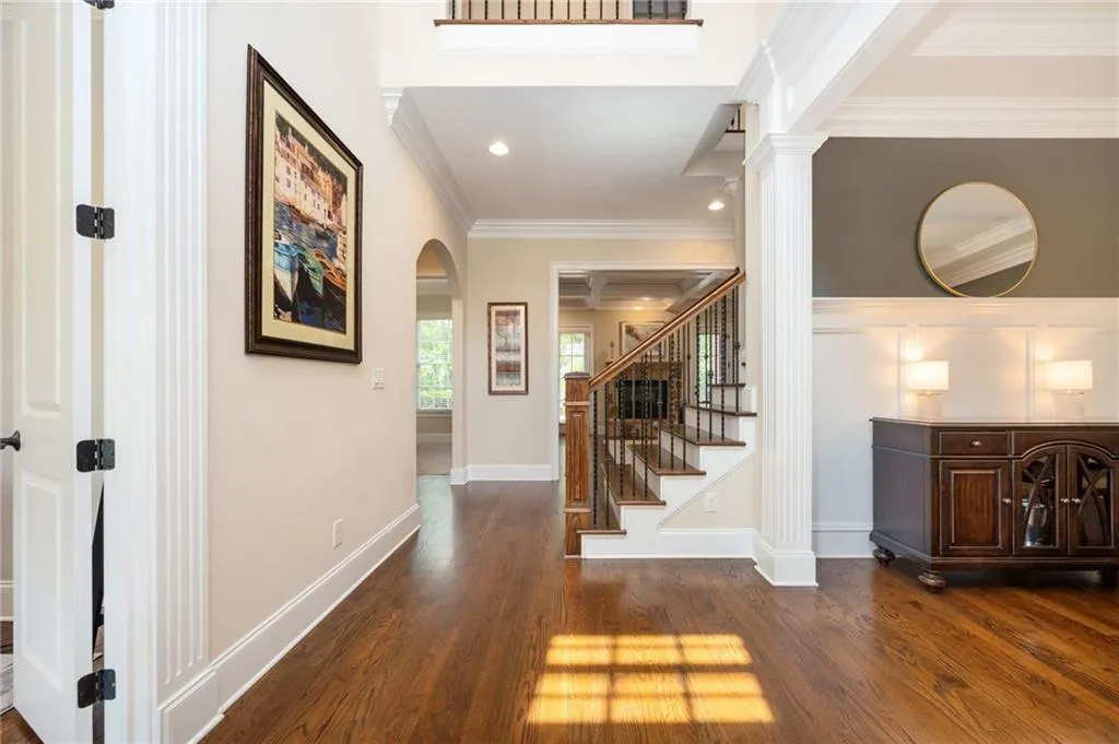 Hall featuring arched walkways and open floorplan
