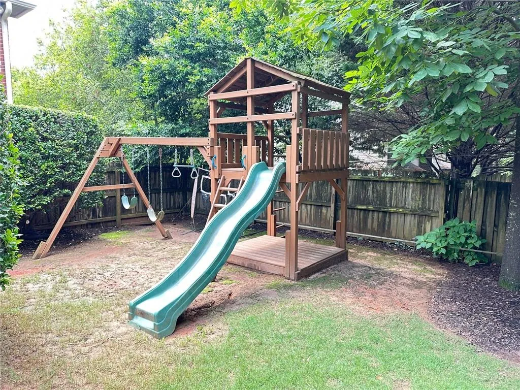 Play area featuring a fenced backyard