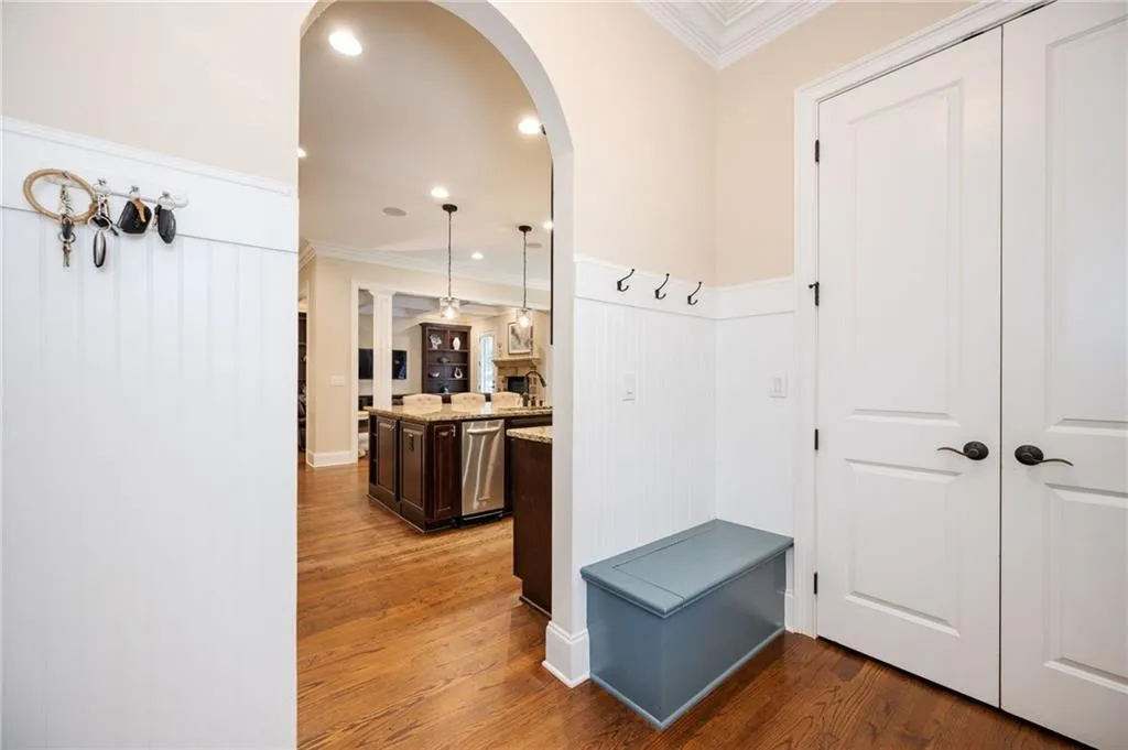 Mudroom featuring a storage bench and coat closet. Connects to all 3 garages and side door.