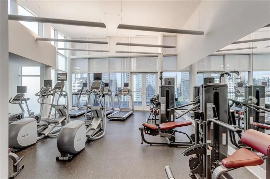 Gym with a healthy amount of sunlight and a high ceiling Gym with a healthy amount of sunlight and a high ceiling