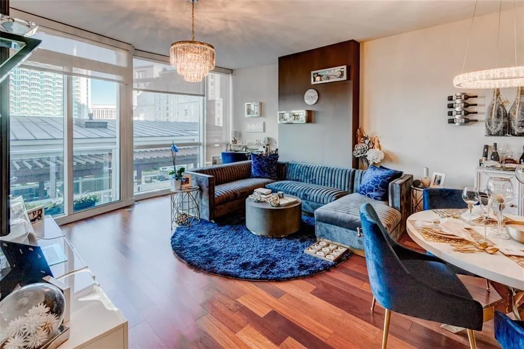 Living room featuring a notable chandelier and hardwood / wood-style flooring Living room featuring a notable chandelier and hardwood / wood-style flooring