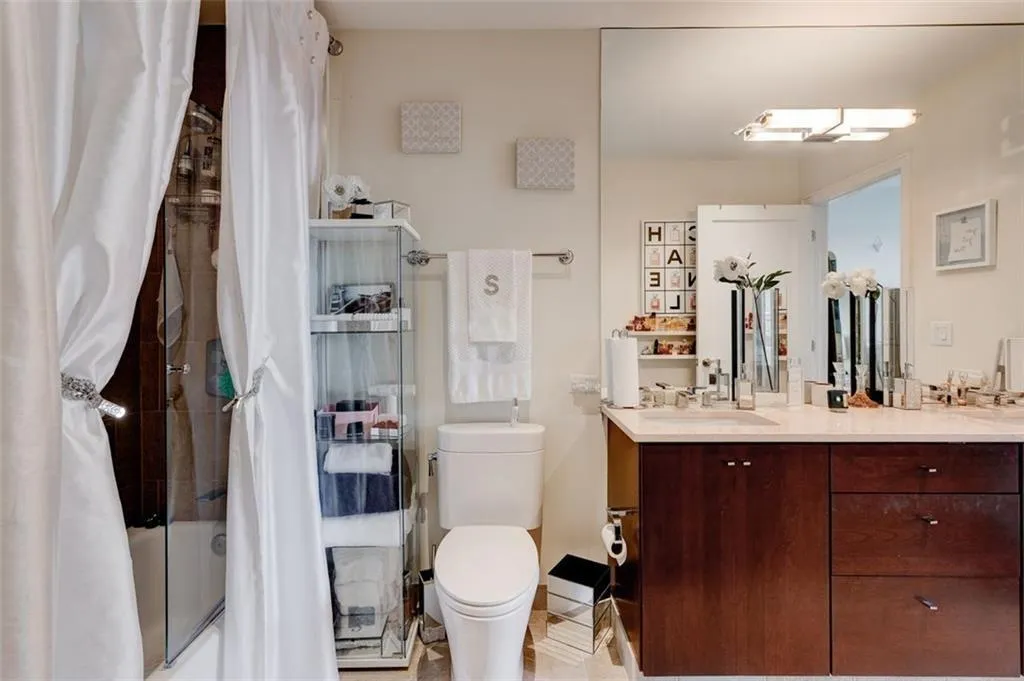 Full bathroom featuring toilet, tiled shower / bath combo, tile flooring, and vanity Full bathroom featuring toilet, tiled shower / bath combo, tile flooring, and vanity