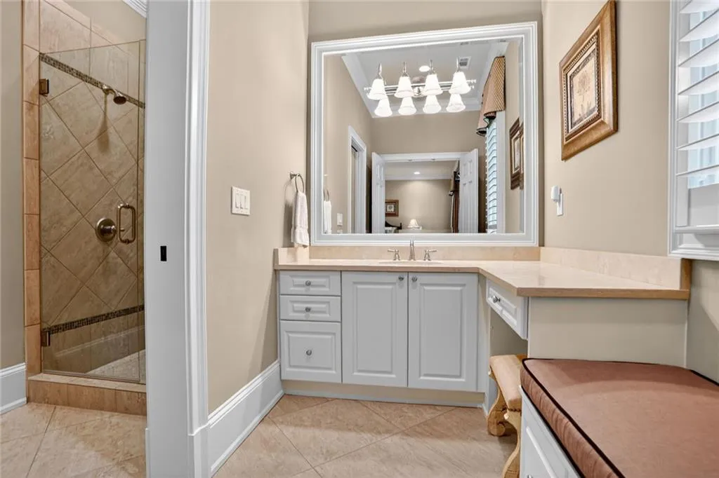 Bathroom with a stall shower, vanity, and light tile patterned flooring