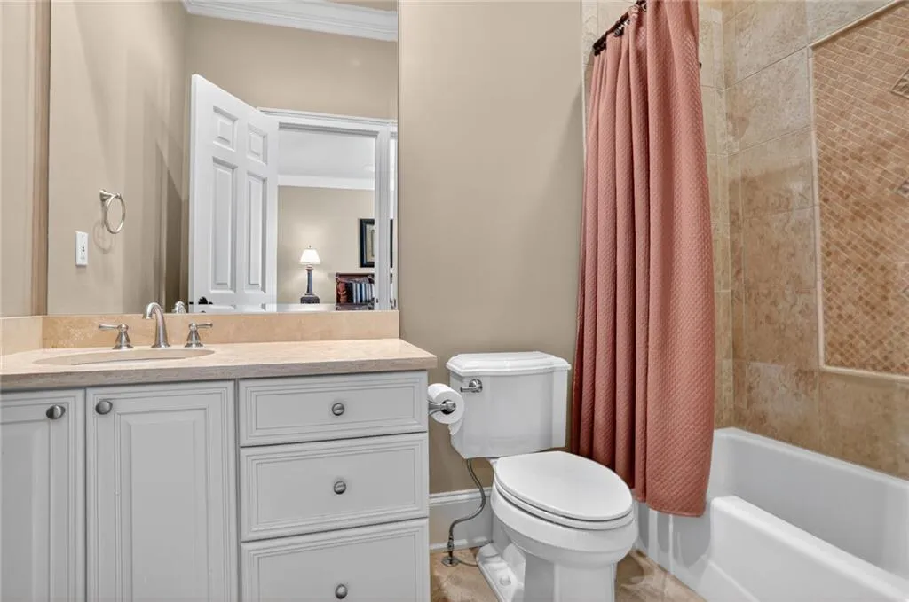 Full bath featuring shower / bathtub combination with curtain, ornamental molding, vanity, and tile patterned flooring