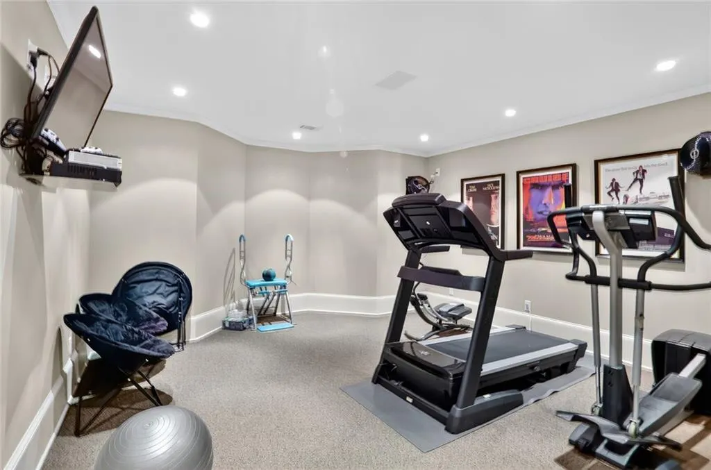 Workout area featuring crown molding, recessed lighting, and carpet