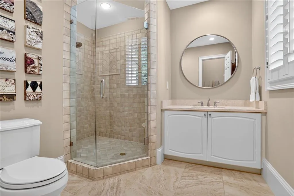Bathroom with a stall shower, vanity, and light tile patterned flooring