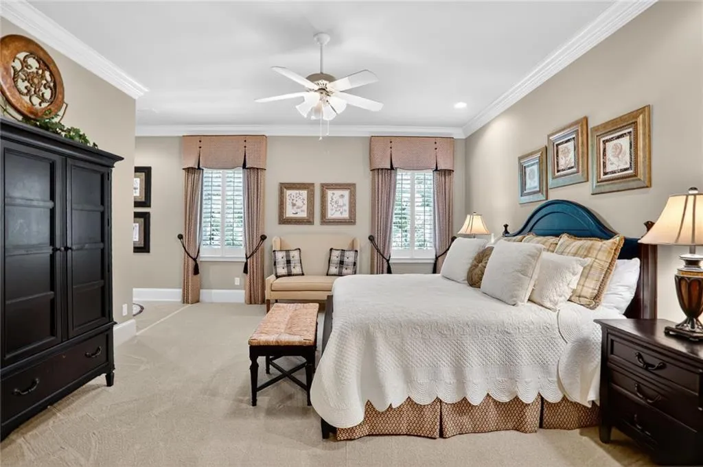 Bedroom with ornamental molding, light colored carpet, a ceiling fan, and recessed lighting