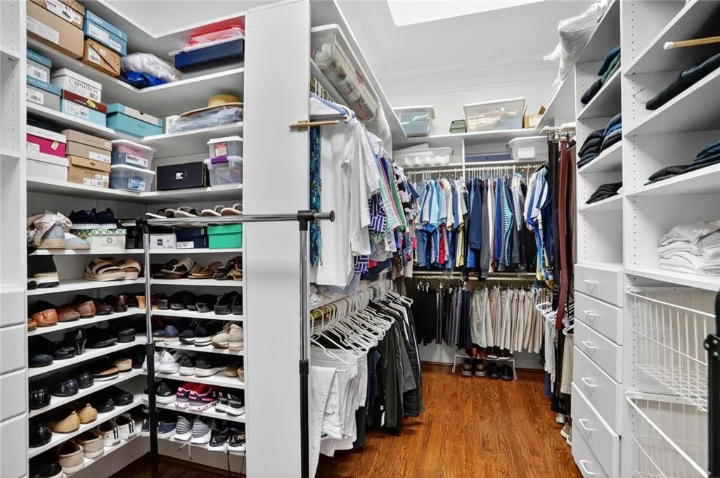 Walk in closet featuring dark wood-style floors