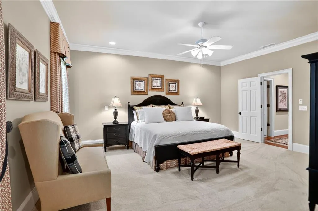 Carpeted bedroom featuring crown molding, a ceiling fan, and recessed lighting