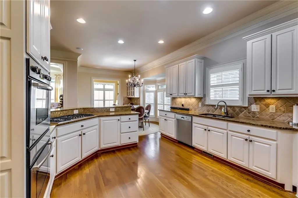 Spacious kitchen with granite counter tops and stainless-steel appliances.