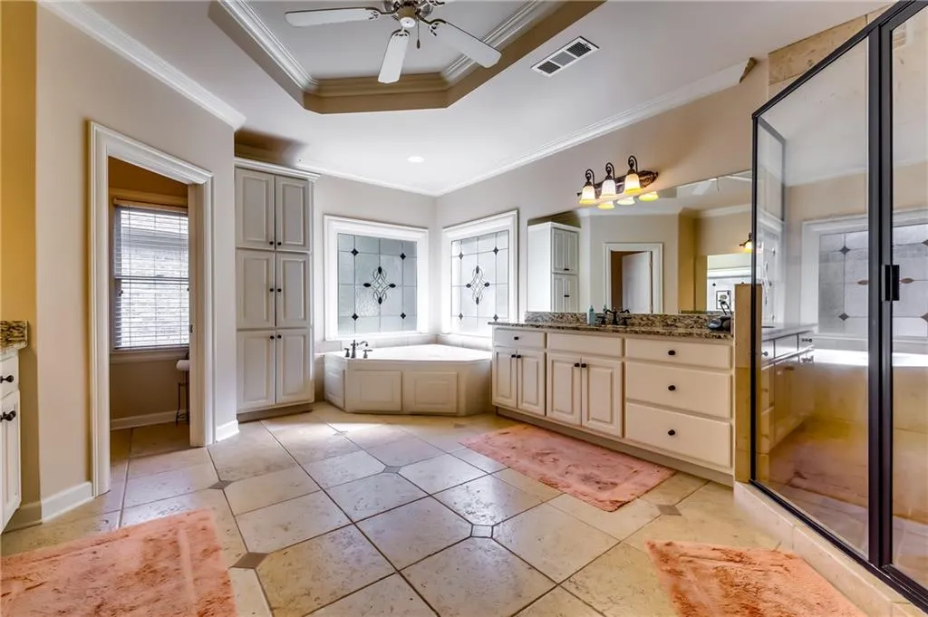 Master bath with jacuzzi and his/hers vanities.