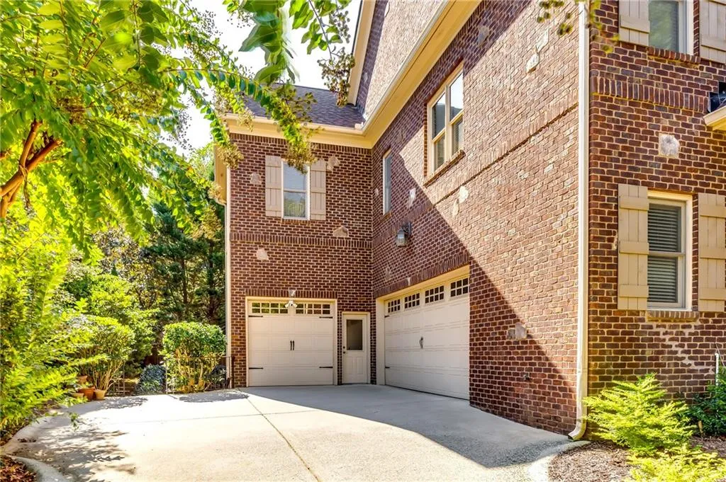 Side view of 3 car garage. Four sides brick house.