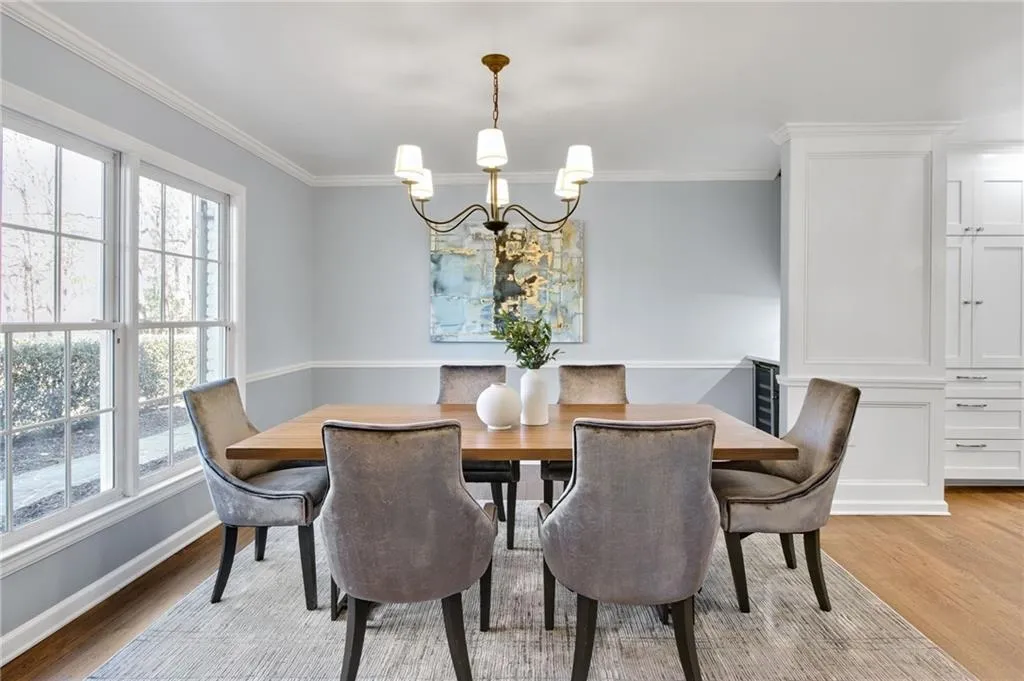 Dining room featuring crown molding, light hardwood / wood-style flooring, and a chandelier