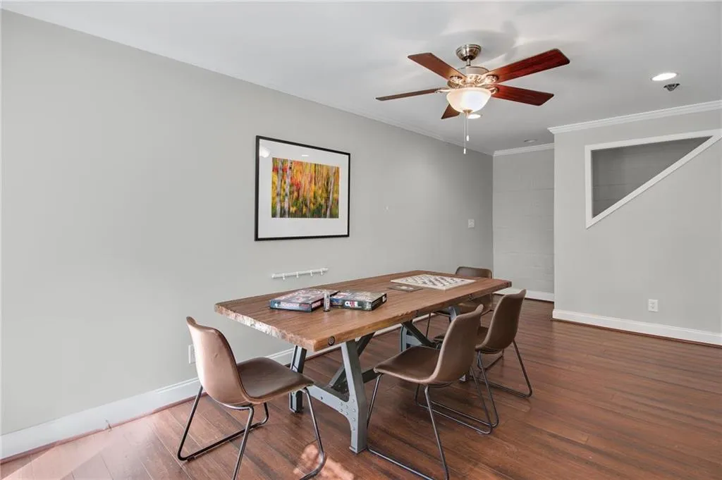 Dining room featuring crown molding, ceiling fan, and dark hardwood / wood-style flooring