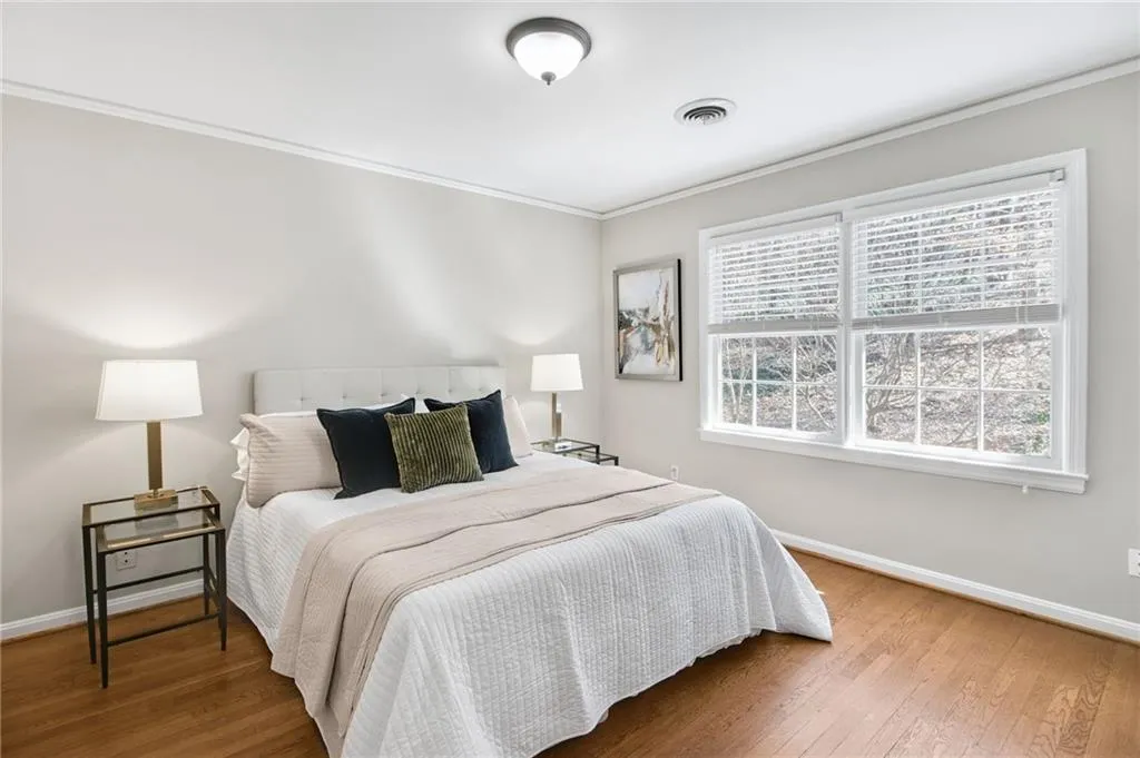 Bedroom featuring ornamental molding and wood-type flooring