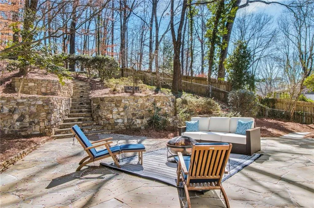 View of patio featuring an outdoor living space with a fire pit