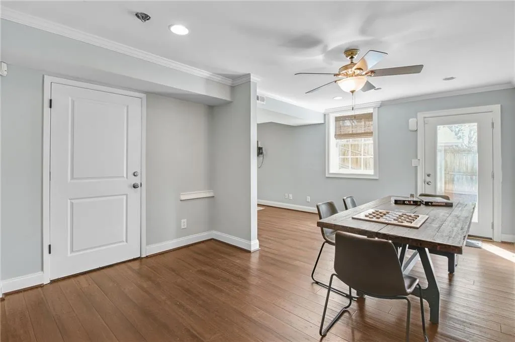 Dining area featuring ceiling fan, ornamental molding, and wood-type flooring