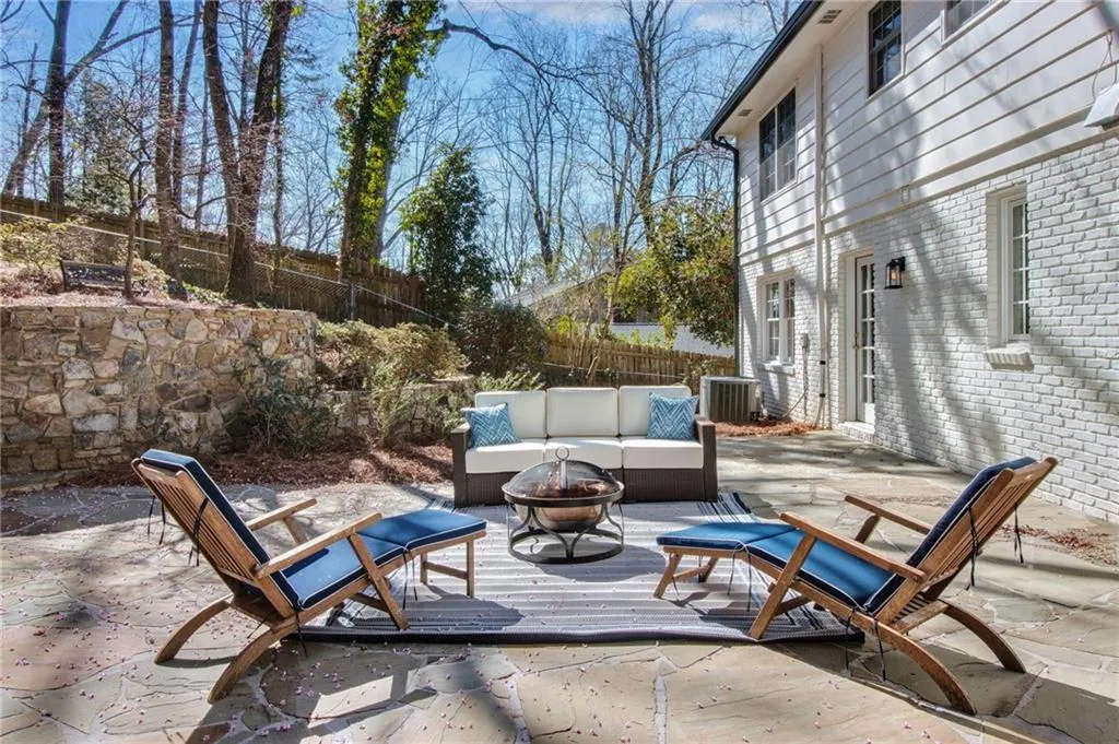 View of patio featuring an outdoor living space with a fire pit and central air condition unit