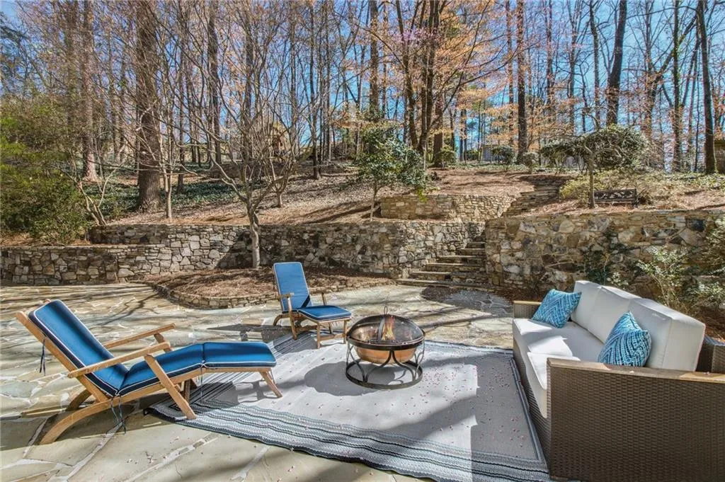 View of patio featuring an outdoor living space with a fire pit