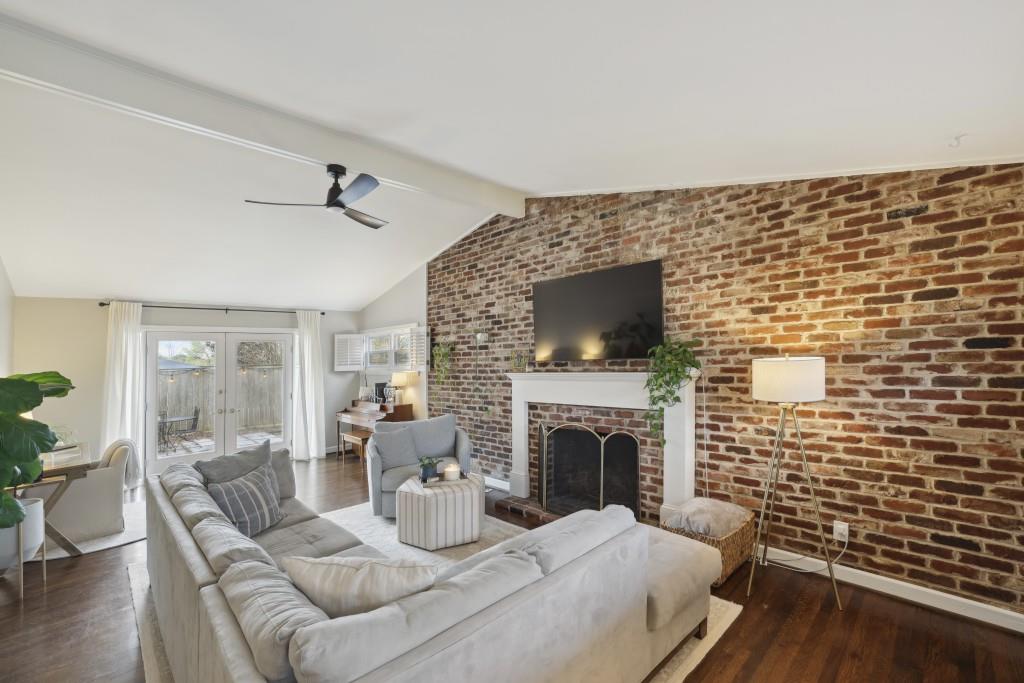 The living area Flows seamlessly through the Living Room's Soaring Ceilings to the Private Backyard.