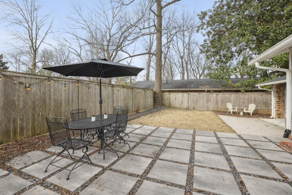 The Backyard is Fully Fenced and Low Maintenanced with the Perfect Mix of Patio of Pavers and Grass.