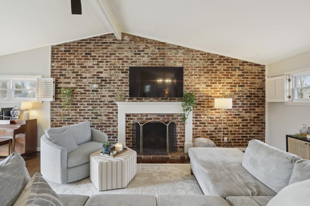 The living area Flows seamlessly through the Living Room's Soaring Ceilings to the Private Backyard.